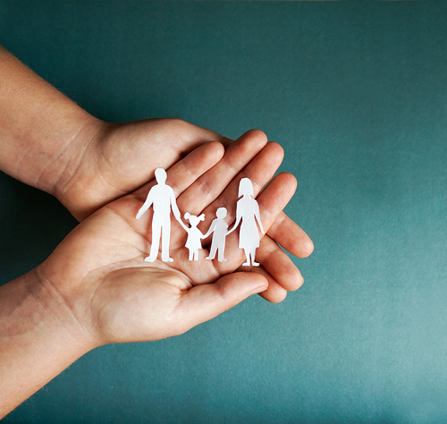 hands holding paper family cutout, social distancing concept, covid19  on the blue color background, family protection